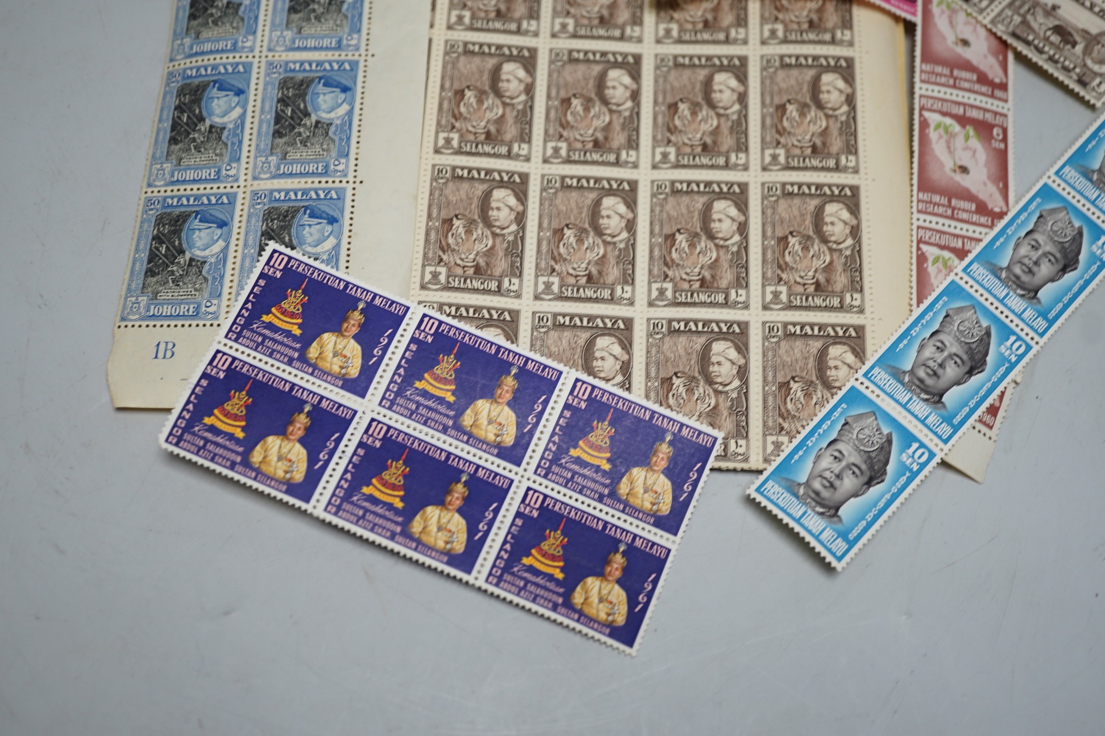A group of World stamps in pockets including Malaya sheets
